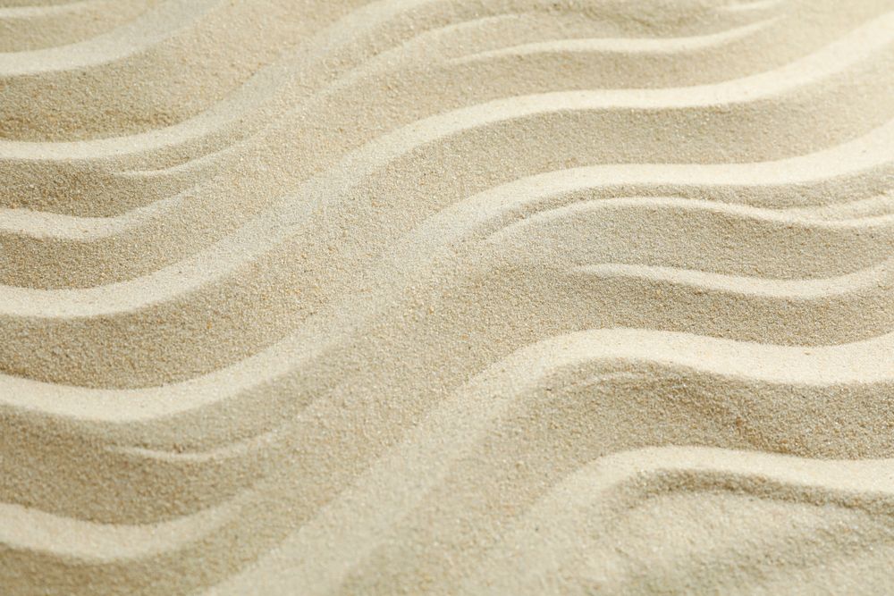 Seamless sand on a whole background, space for text. Summer vacation backdrop