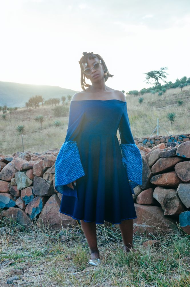 Zulu wedding guest in blue dress outside