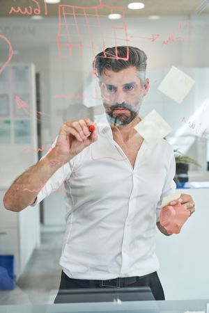 Serious man creating new sample of covid mask