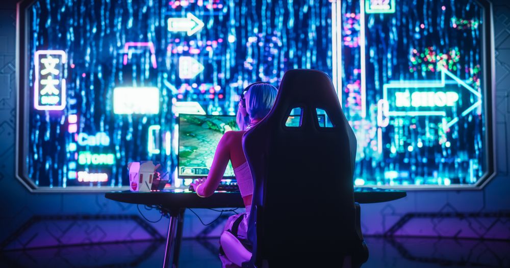 Female Gamer Playing Fantasy Strategy Video Games Online on a Computer.