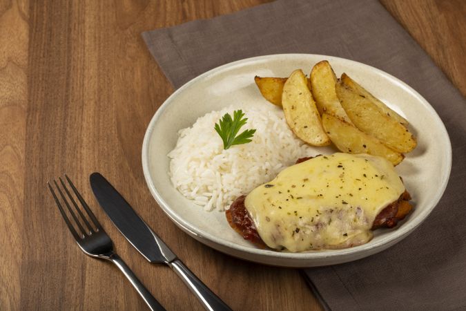 Parmigiana steak with rice and roasted potatoes. Typical Brazilian dish.