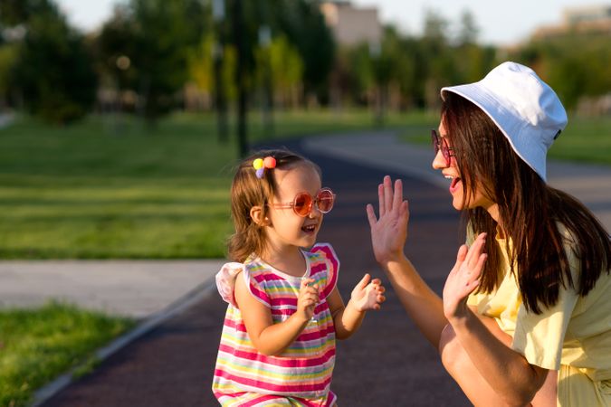 Toddler girl and mom playing outside
