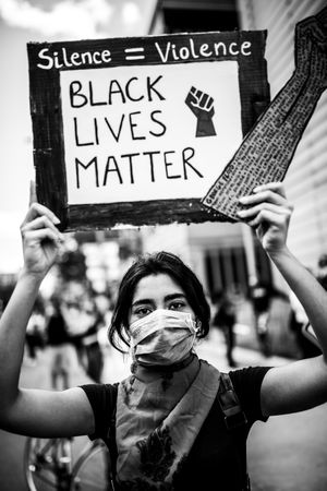 MONTREAL, QUEBEC, CANADA – June 7 2020- Woman holding a Black Lives Matter sign at protest