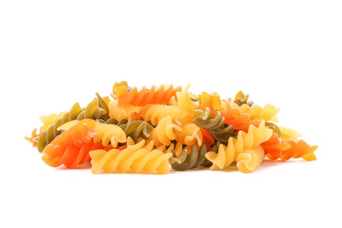 Pasta isolated on bright background, closeup. Dry uncooked whole pasta