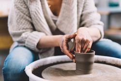Crop potter shaping vessel on wheel