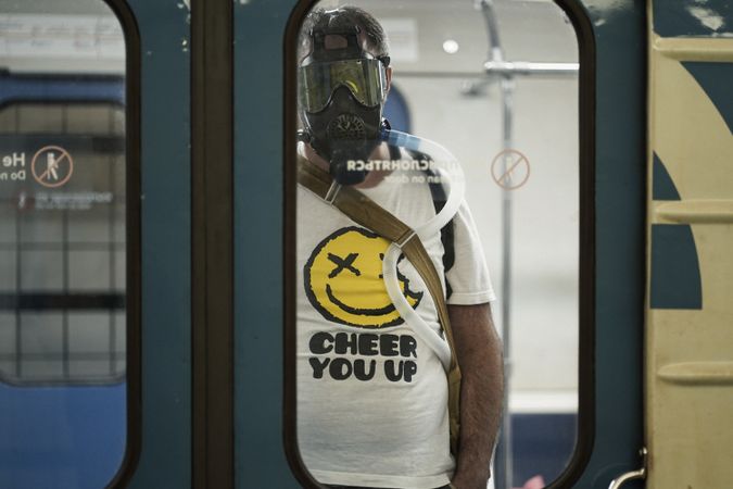 Man with gas mask standing in train
