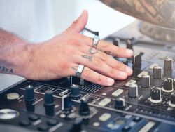 Crop man using professional DJ equipment