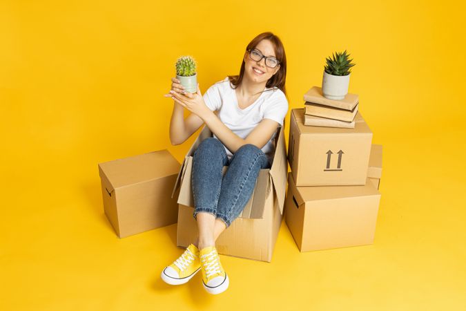 A woman with folded things in a box, moving