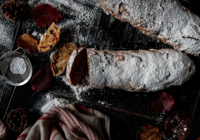 Pieces of Stollen near sieve and autumn leaves