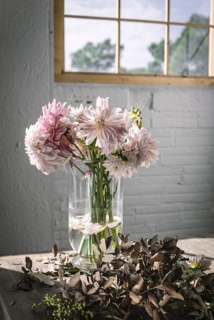 Bunches of flowers in vases on table