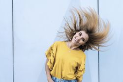 Young woman shaking hair