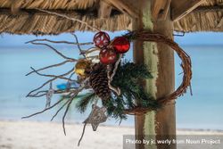 Minimal Christmas wreath hanging on a beach shack 4jDkv0