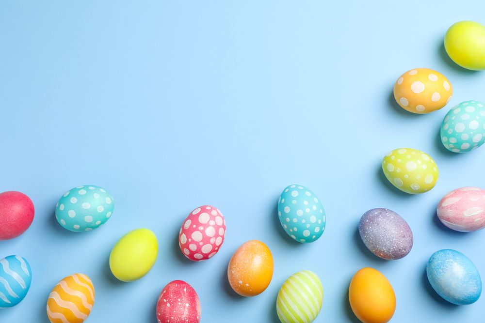 Flat lay composition with Easter eggs on color background, space for text. Top view