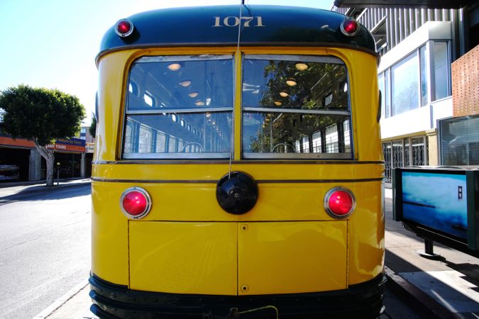 Yellow bus on modern city street