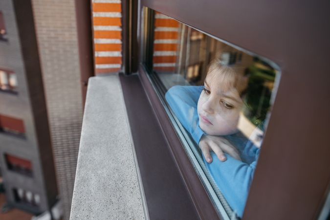 Sad girl looking out the window