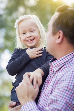Adorable Little Girl Having Fun With Daddy Outdoors