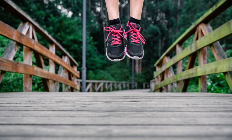 Athlete woman feet jumping outdoors