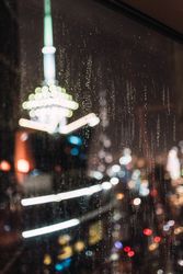 Night city through wet glass