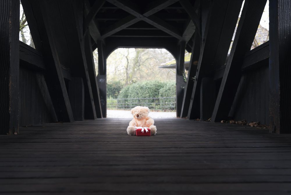 Stuffed bear toy and gift on a bridge