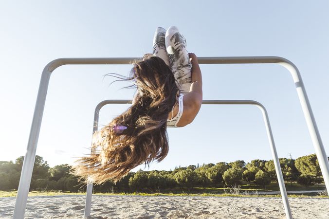 Woman training on parallel bars