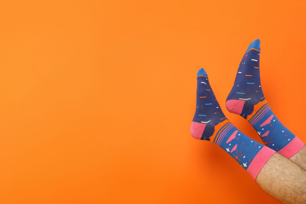 Colored socks with a print on men's feet.