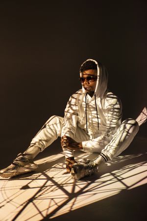 Black man dancing under bright light