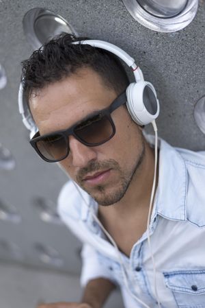 Man relaxing outside while listening using headphones