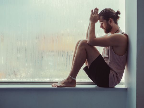 Man in mindfulness on window sill