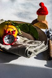 Wintry table setting with tangerine and Santa hat decoration