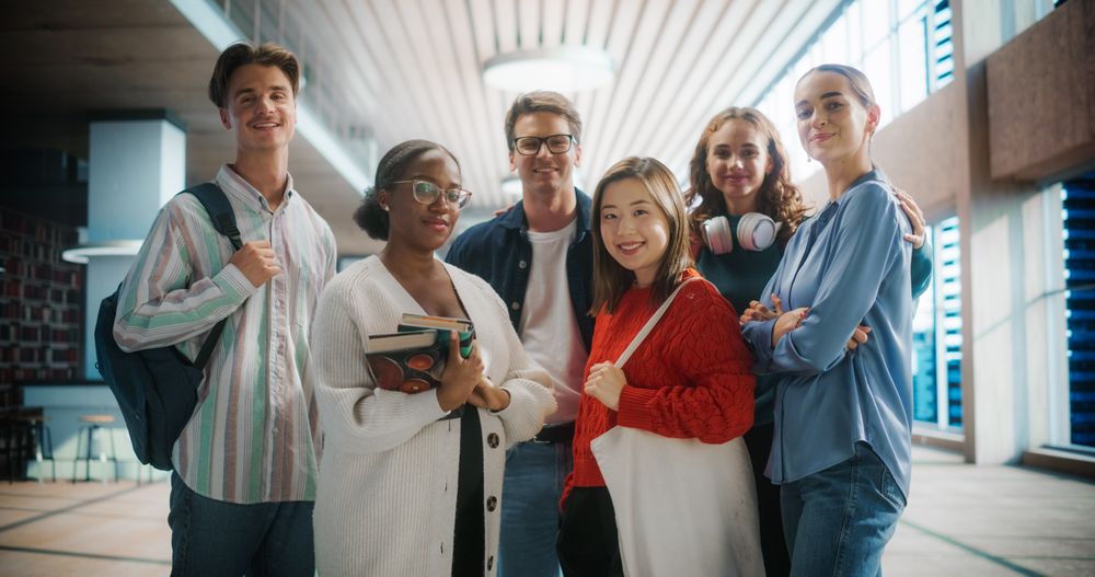 Diverse Group of Students Posing in Modern University Hallway.