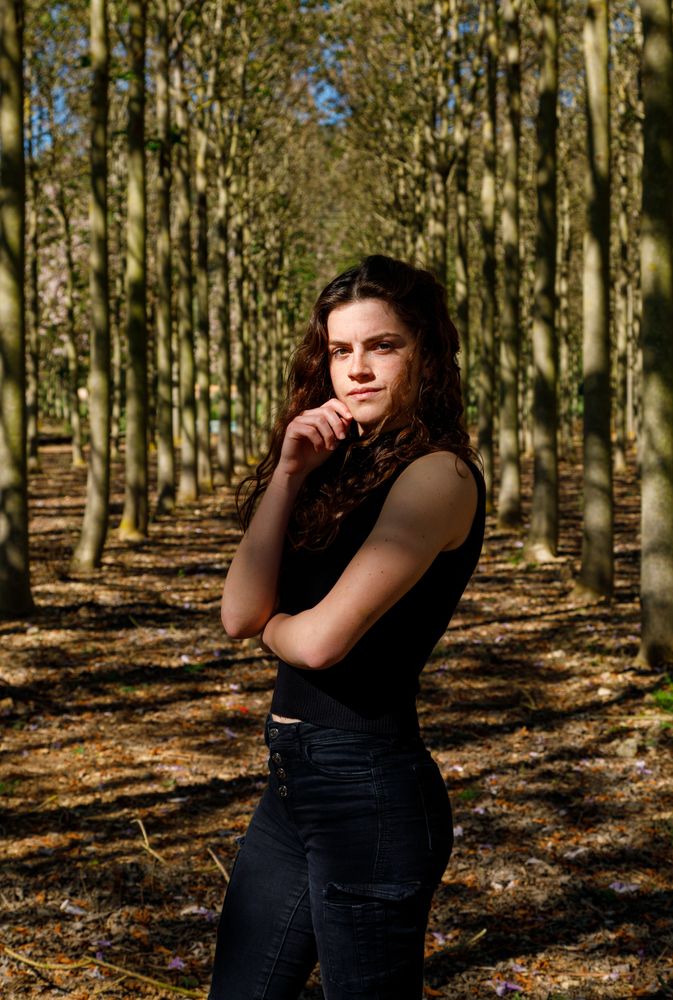 Fit teenage girl standing in forest