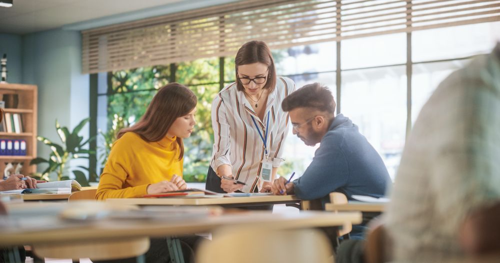 Positive Female Teacher Giving Advice, Answering Questions, and Motivating Students.