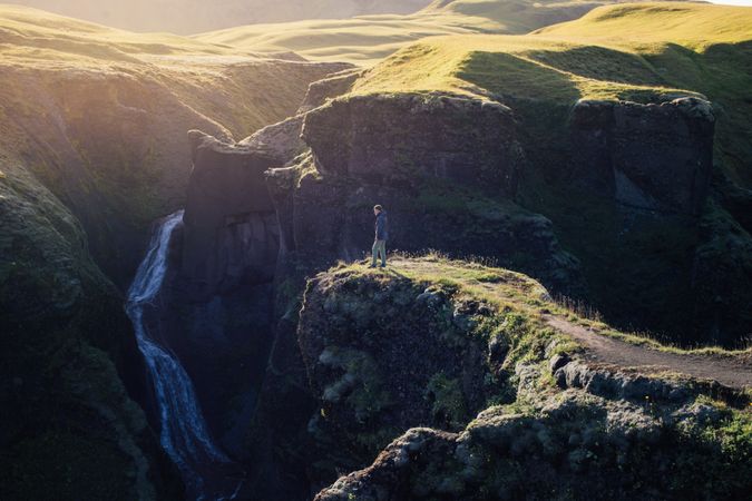 Man standing on edge of cliff