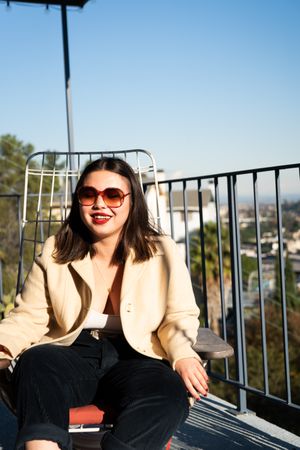 Woman smiling with eyes closed outside on patio