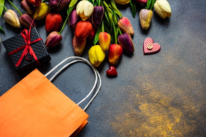 Top view of counter with tulips and wrapped presents, and bag