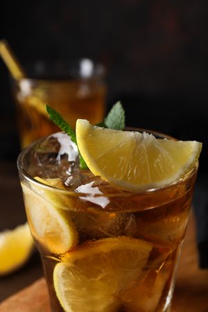 Glass of iced tea with orange slices close-up