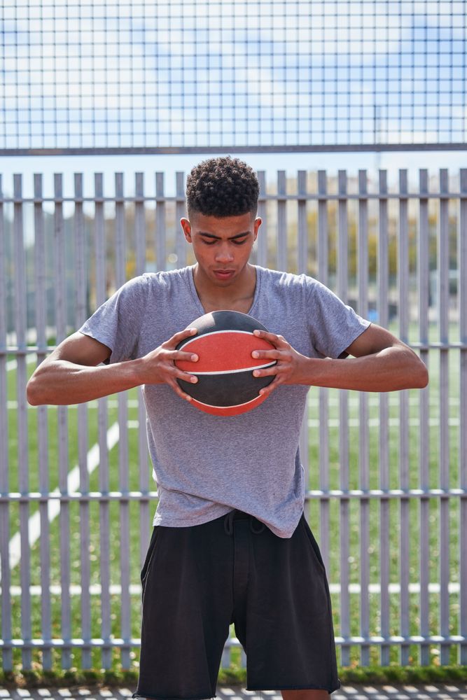 Portrait of young man with basketball