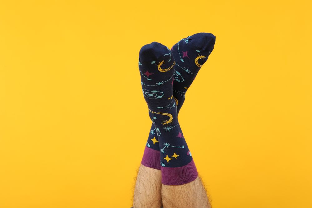 Casual clothes and wearing concept - socks, clothes for foot