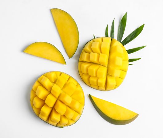 Flat lay composition with ripe mangoes on blank background