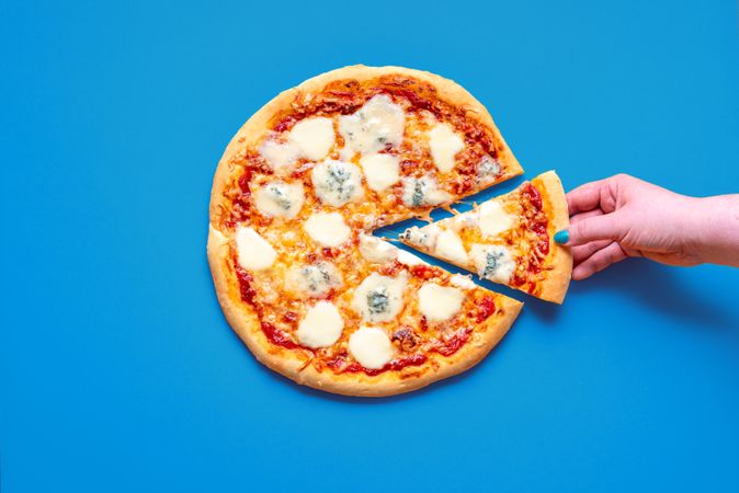 Pizza quattro formaggi, top view on a blue table