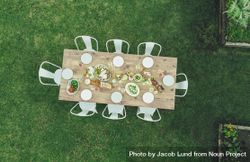 Aerial view of table setting outdoors in garden restaurant with empty chairs 5RK2W4
