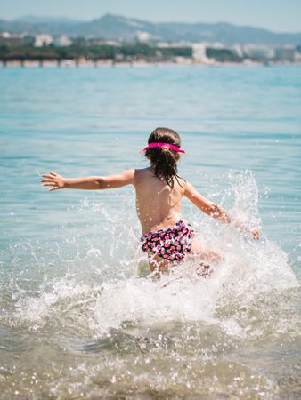 Cheerful girl having fun in warm sea