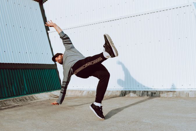 Trendy male flipping on street
