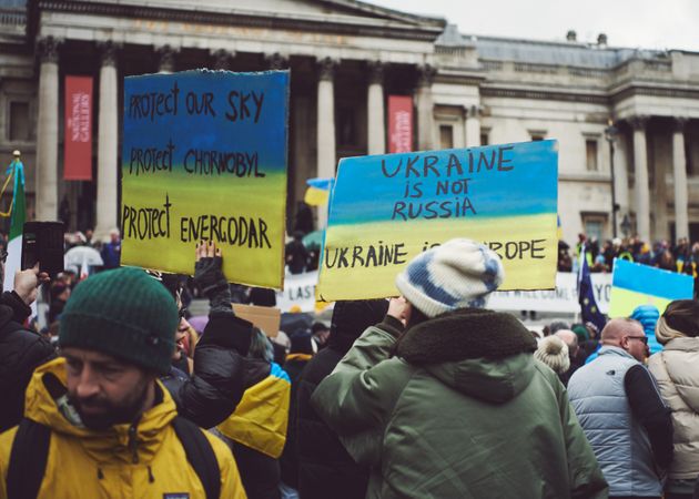 London, England, United Kingdom - March 5 2022: Backs of people holding anti-Ukrainian war signs