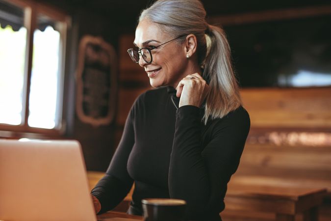 Woman at cafe using laptop computer