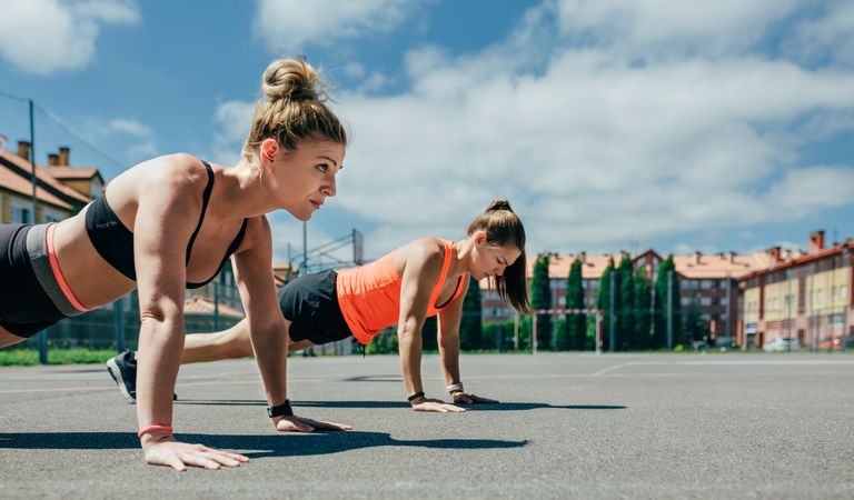 Sportswomen doing push-ups