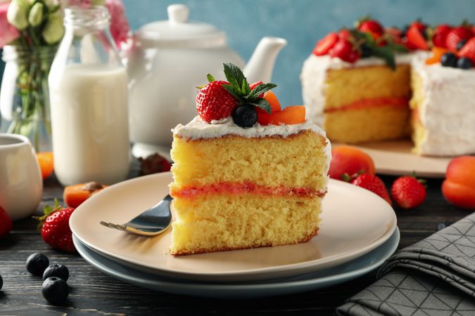 Composition with delicious berry cream cake on wooden table. Tasty dessert