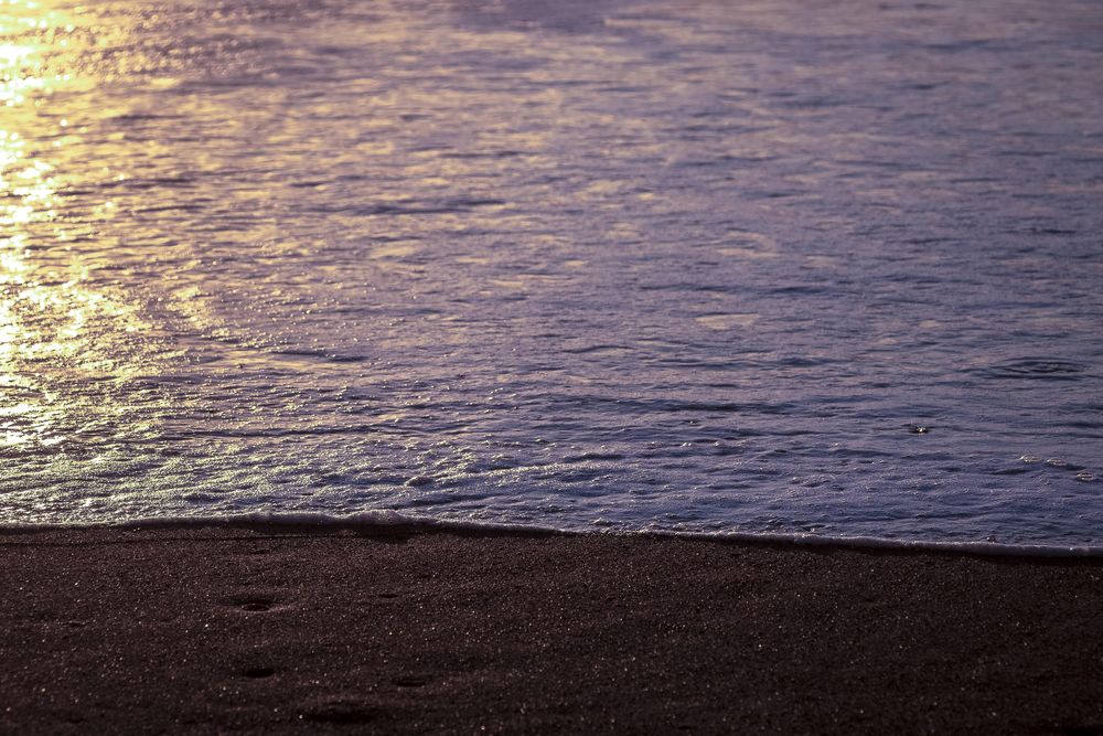 Ocean and sandy beach with late sun light