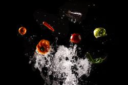 Flying fresh vegetables in splashes of water