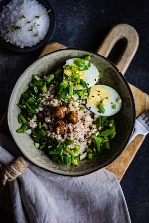 Top view of buckwheat bowl with hard boiled eggs and green onions